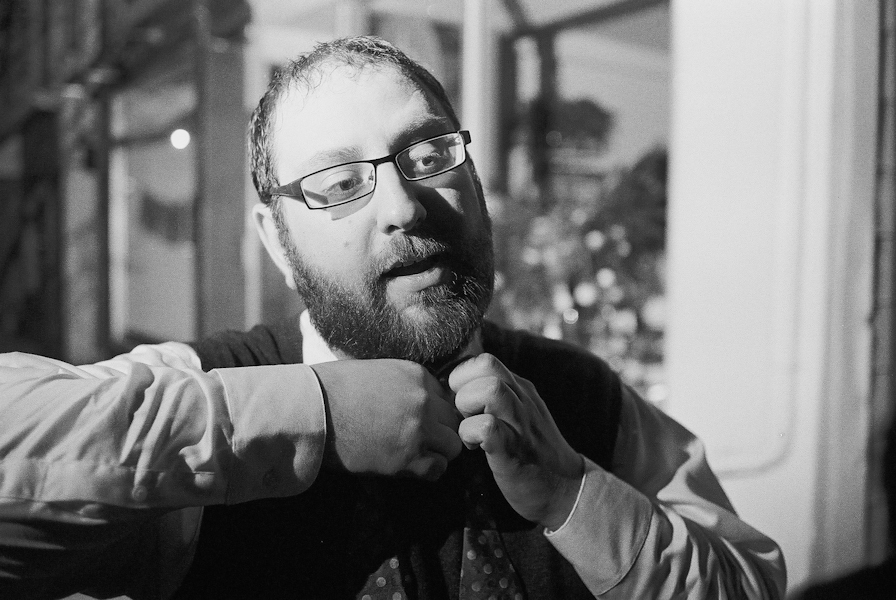 Tying a tie. Photo by Nicholas Warzin